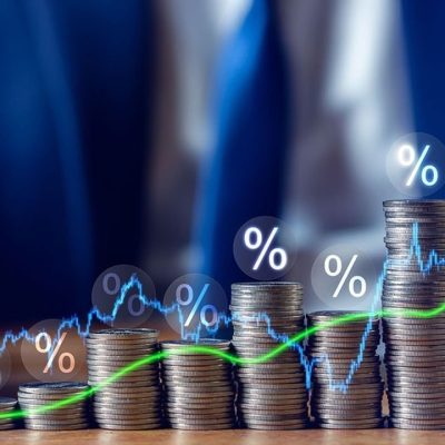 Businessman putting down money, pointing with pen and showing candlestick symbol for investing, finance, saving money, interest rate or dividend investment, business growth concept.